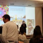 The speaker shares on the podium photo 2.