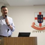 The speaker shares on the podium photo 2.